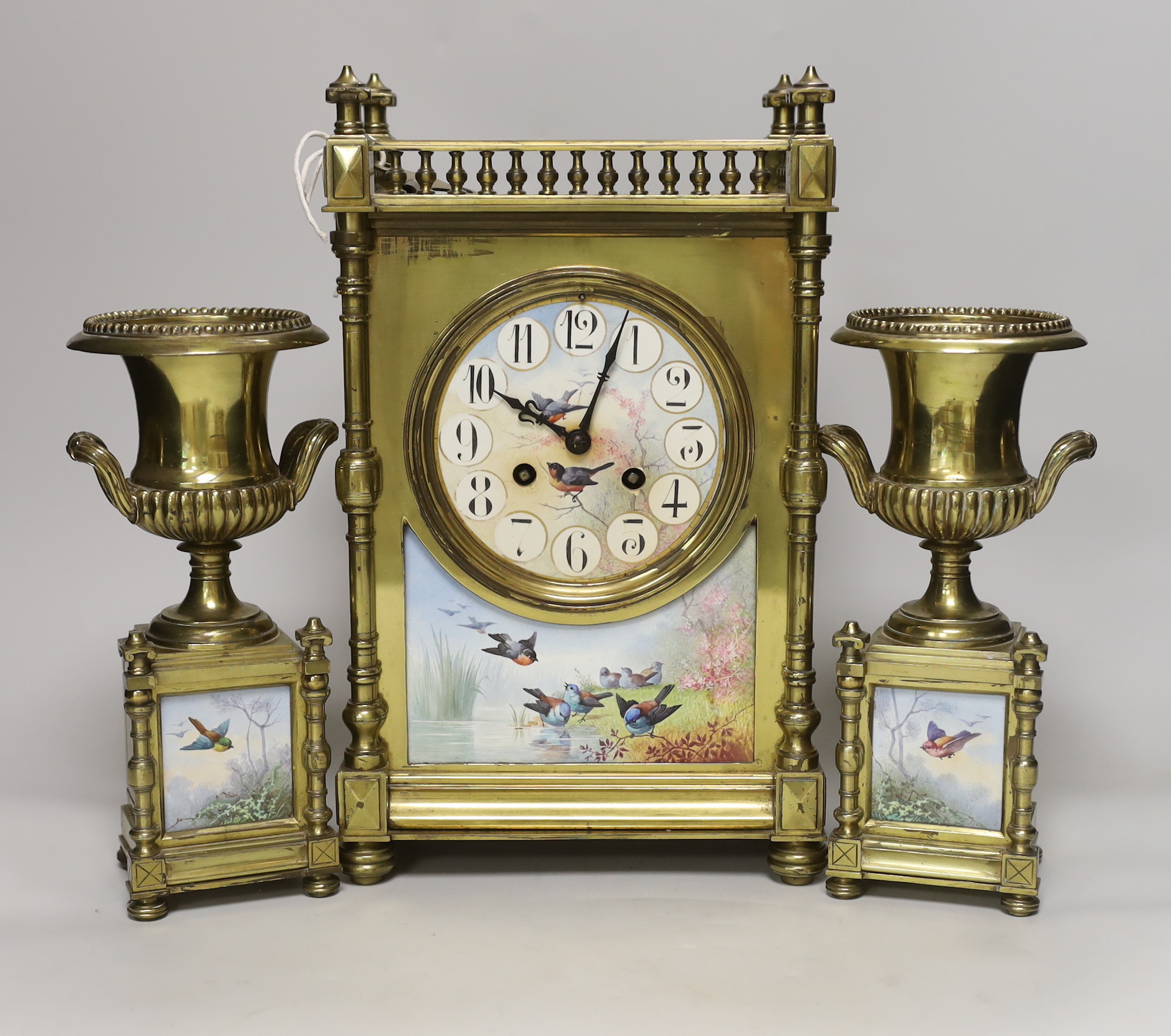 A French Aesthetic period brass and porcelain panelled clock garniture, clock 34cm high